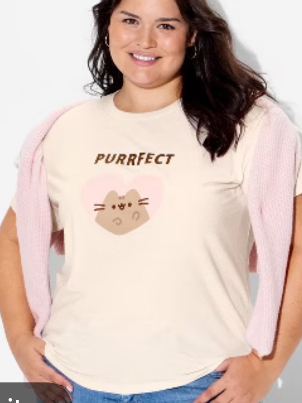 Pusheen graphic t-shirt features a cream color with a
“Purrfect" heart graphic